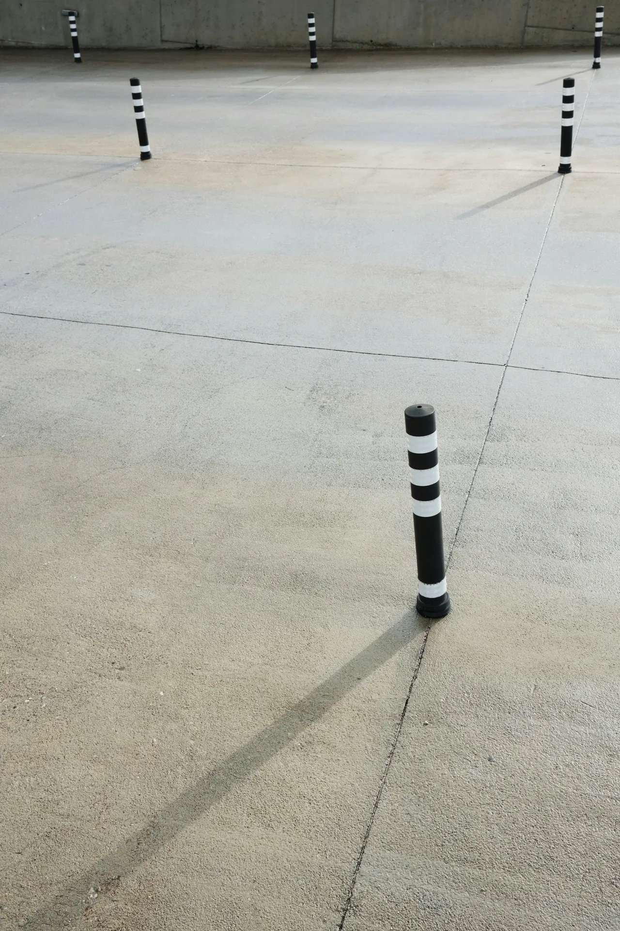 broom-finished concrete parking lot with bollards in Las Vegas