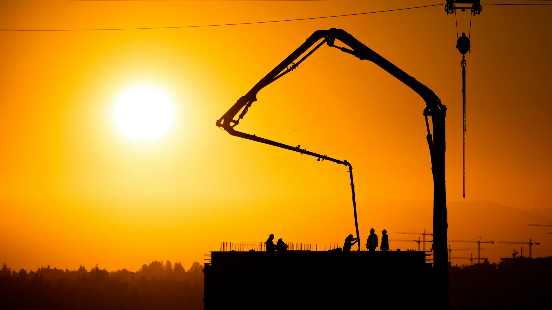 concrete boom pump on a Las Vegas construction site at sunset