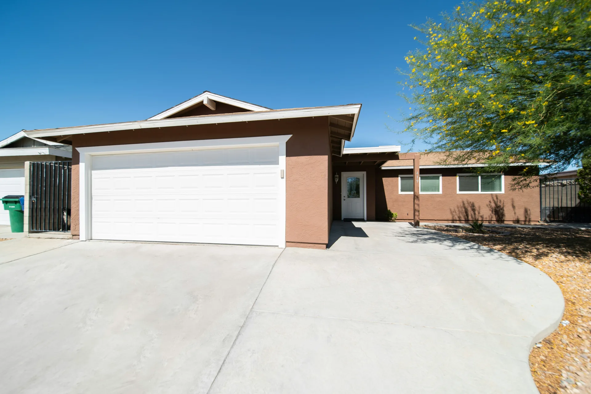 broom-finish concrete driveway at a Las Vegas stucco home