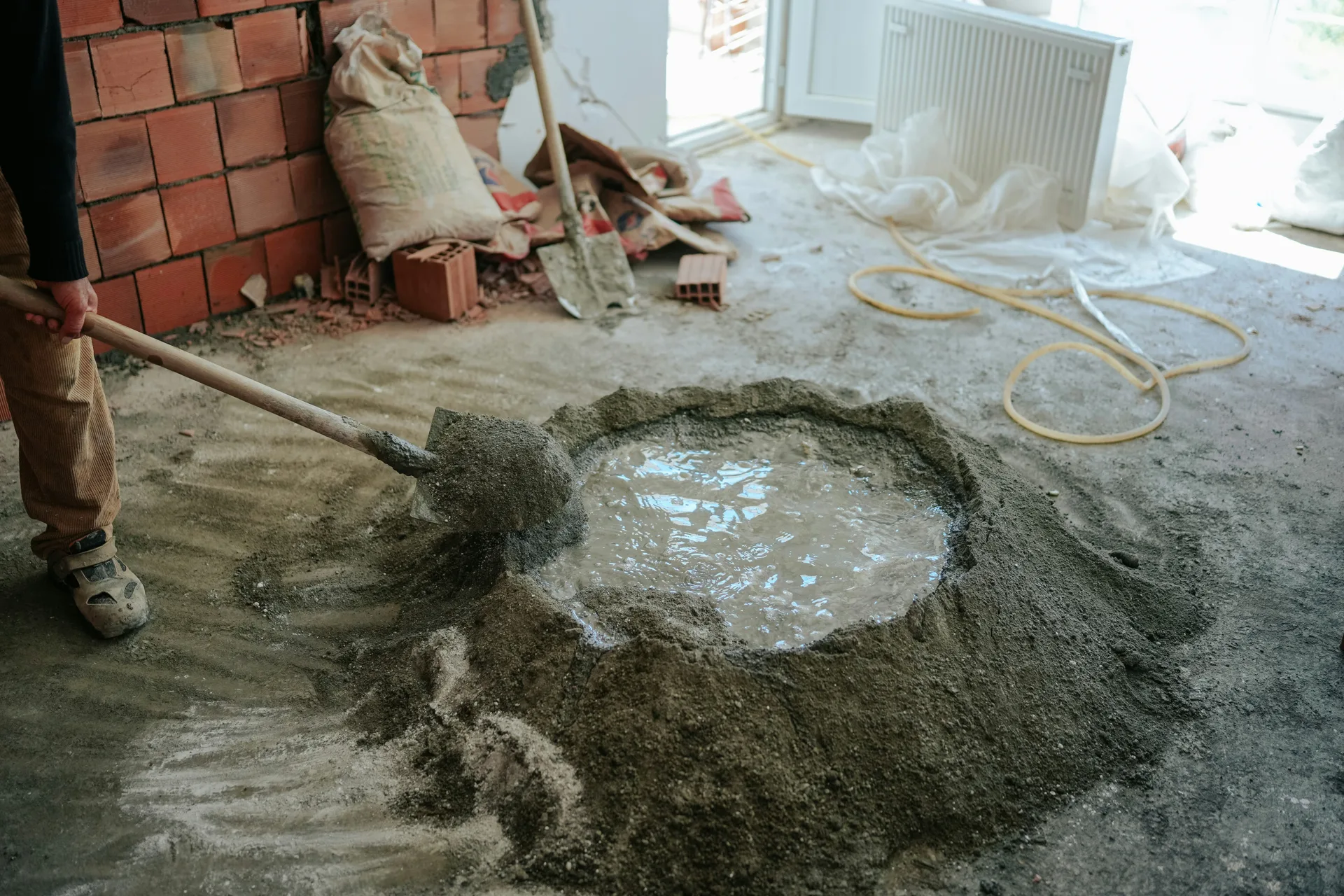 basement renovation with concrete and plumbing trades coordinated on site