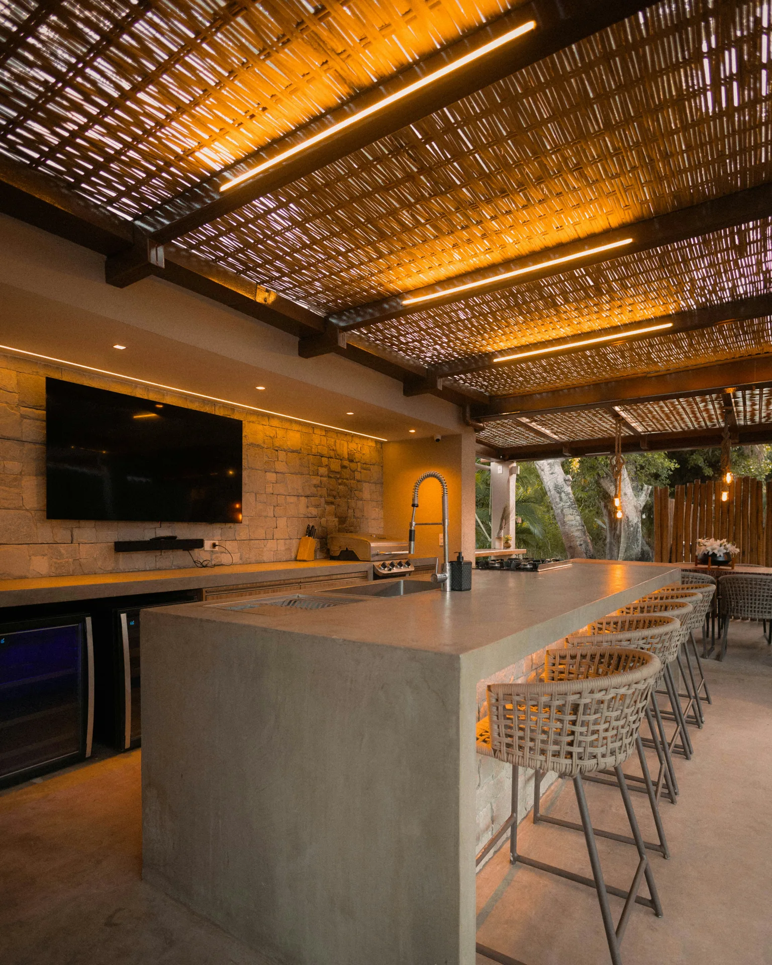 concrete outdoor kitchen bar under a pergola at a Las Vegas home